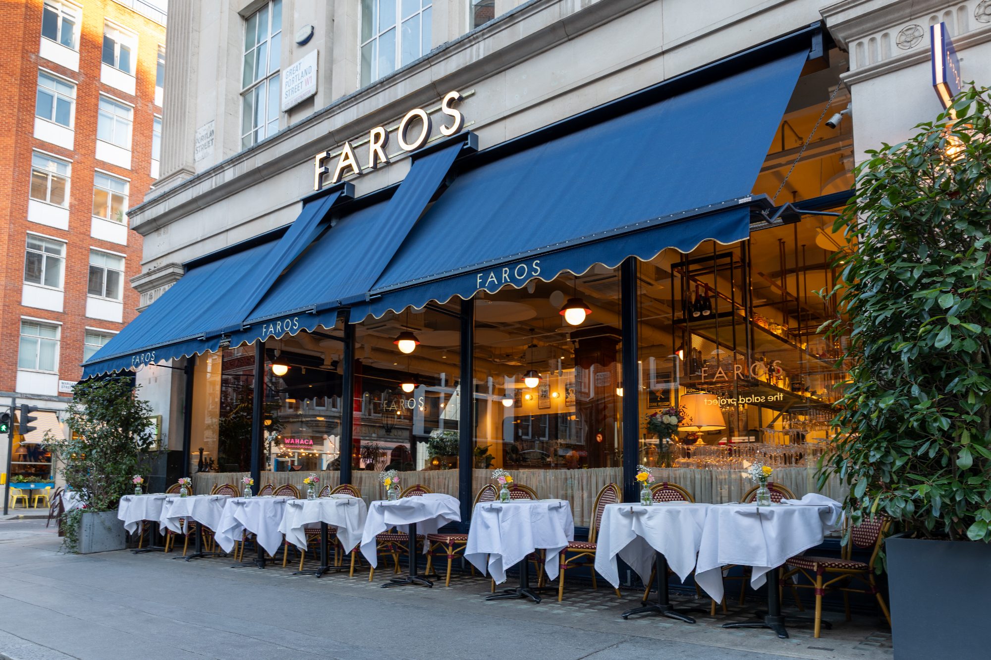 Faros awning structure and timber glazing bars seen along the pavement